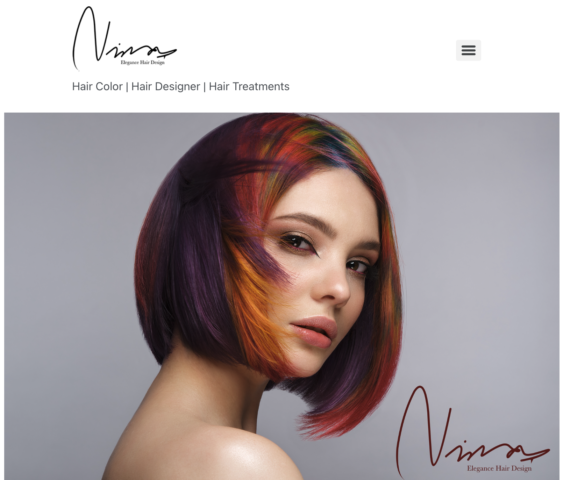 Woman with vibrant, multi-colored short hair styled elegantly.